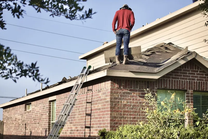 Professional roofer working on a residential roof in Yarmouth Port